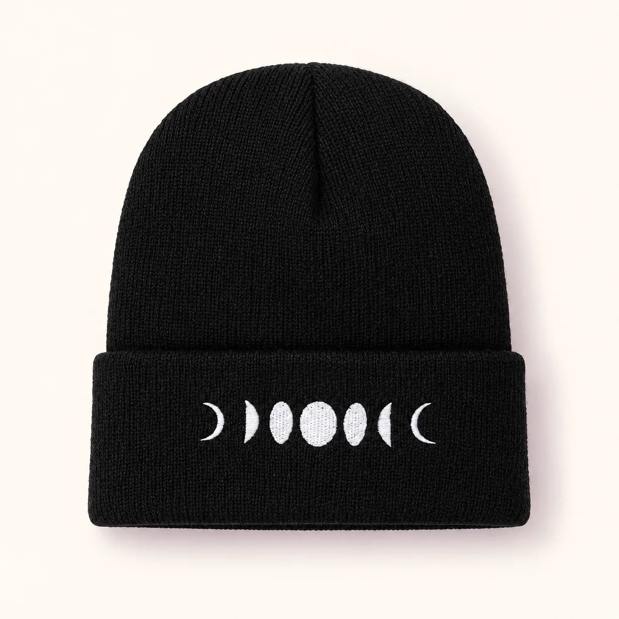 Black knitted Full Moon Hat with seven white moon phases embroidered across its folded cuff Black knitted Full Moon Hat with seven white moon phases embroidered across its folded cuff