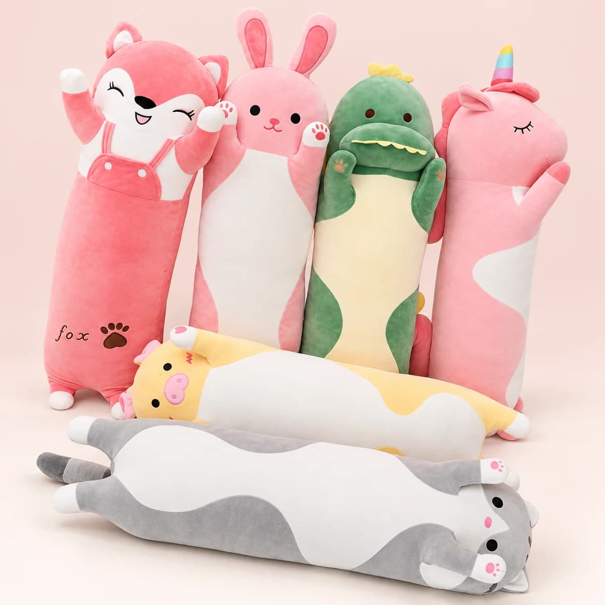 Six long animal plushies: pink fox, rabbit and unicorn, green dinosaur, yellow pig and grey cat Six long animal plushies: pink fox, rabbit and unicorn, green dinosaur, yellow pig and grey cat