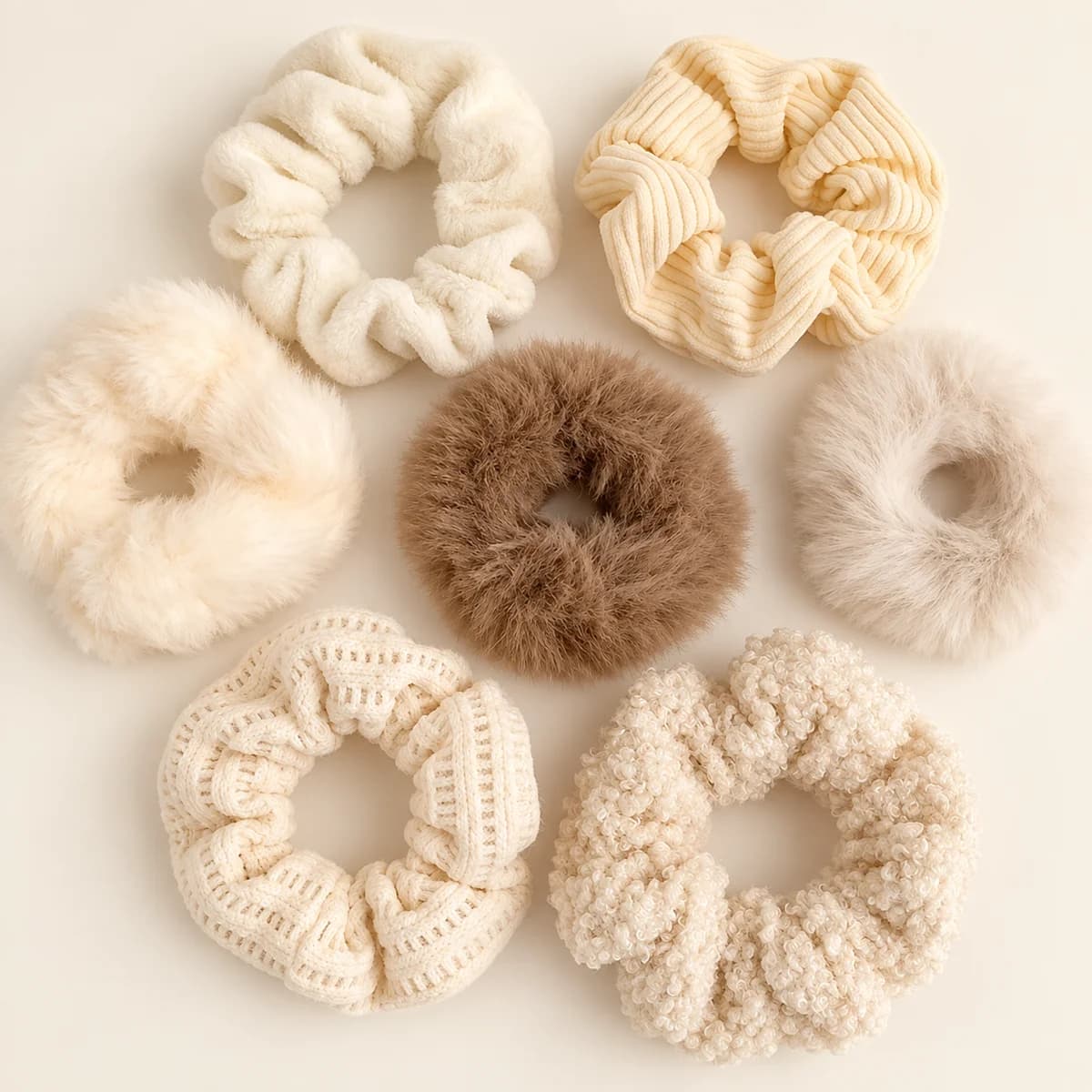 Set of seven cream, oatmeal and brown scrunchies with plush, ribbed and knitted textures Set of seven cream, oatmeal and brown scrunchies with plush, ribbed and knitted textures