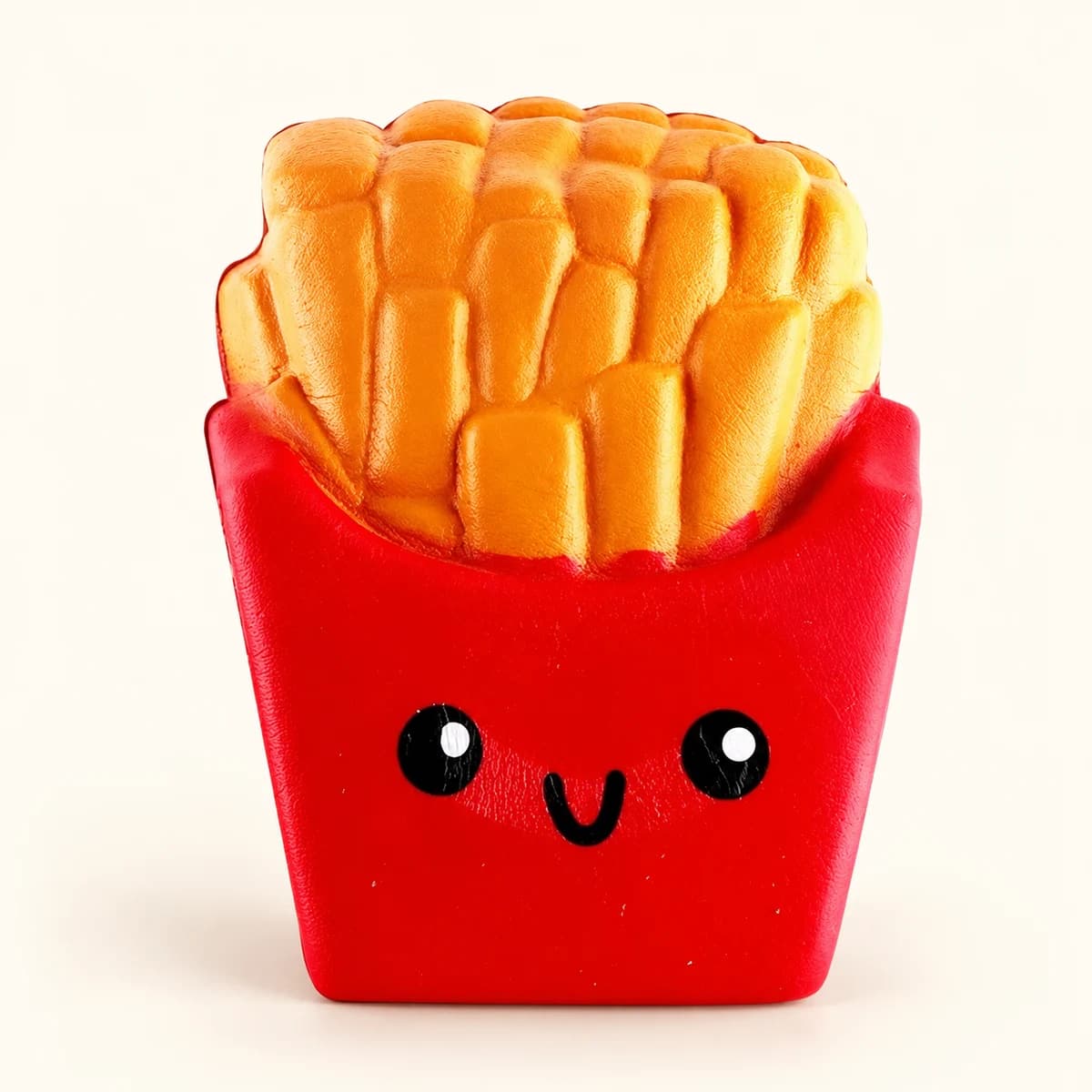 Smiling red french-fries carton squishy with golden molded fries and black eyes Smiling red french-fries carton squishy with golden molded fries and black eyes