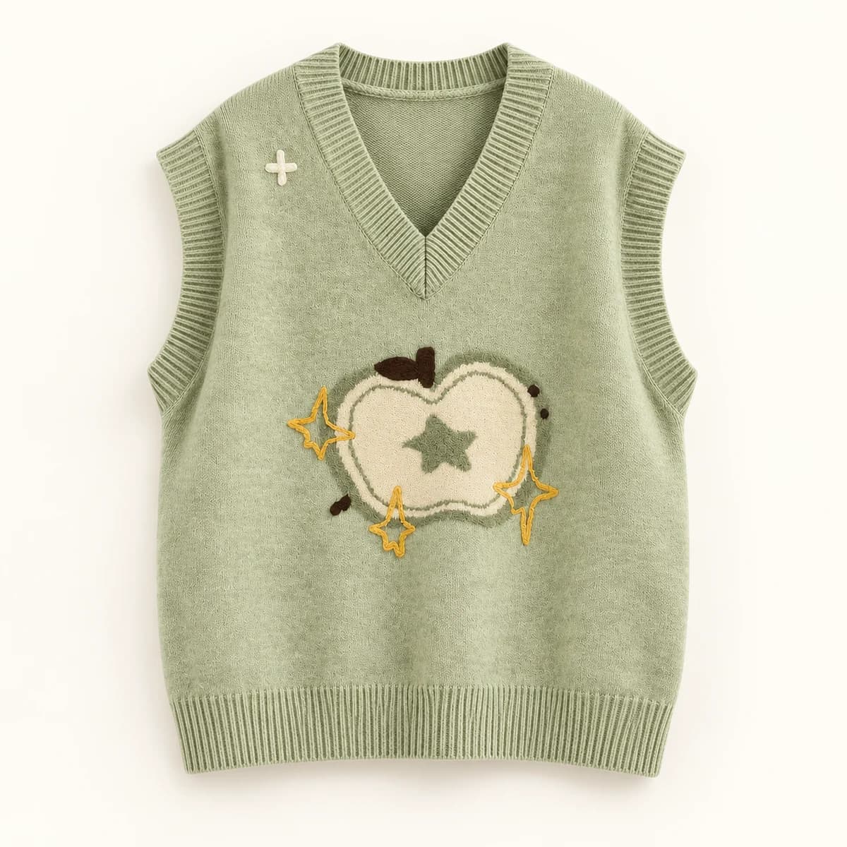 Sage green knitted vest with an apple motif and yellow embroidered sparkles Sage green knitted vest with an apple motif and yellow embroidered sparkles